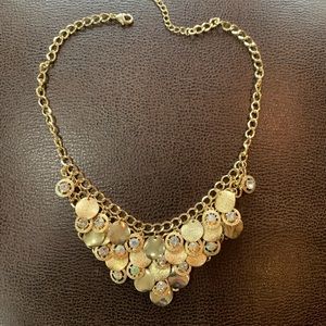Gold costume jewelry with discs and sparkles